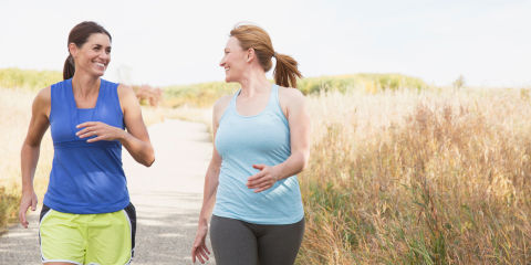 Two women walking together outdoors.