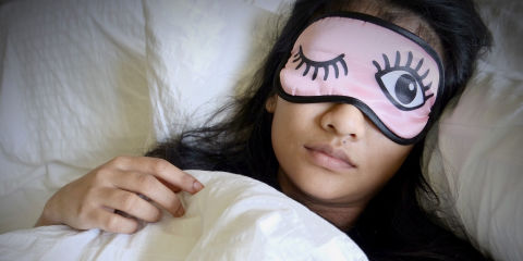 Woman sleeping using eye mask