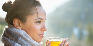 Woman wearing scarf drinking tea
